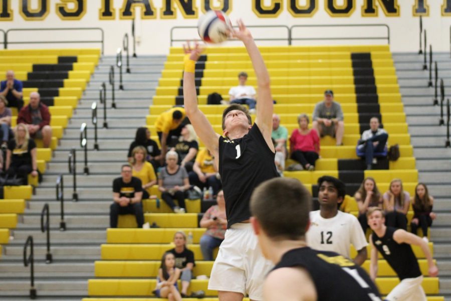 Junior+setter+Brandon+Long+setting+the+ball+to+teammate+and+outside+hitter+Ryan+Owens+during+the+conference+opener+game+against+Naperville+Central+on+April+15.