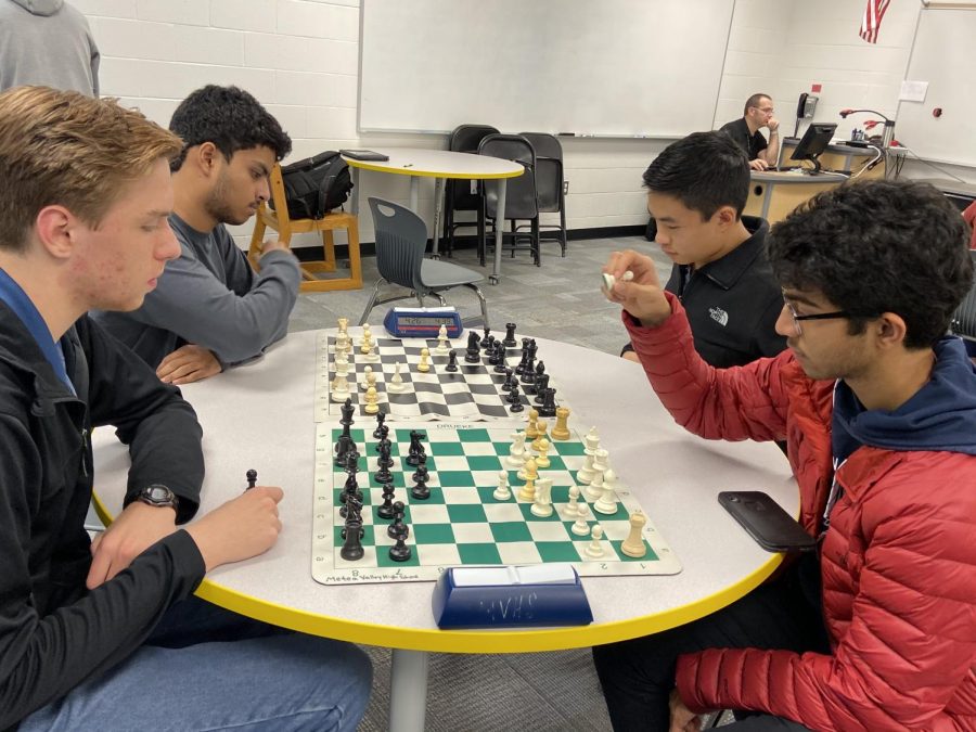 Chess  team members practice matches to prepare for their meets. 