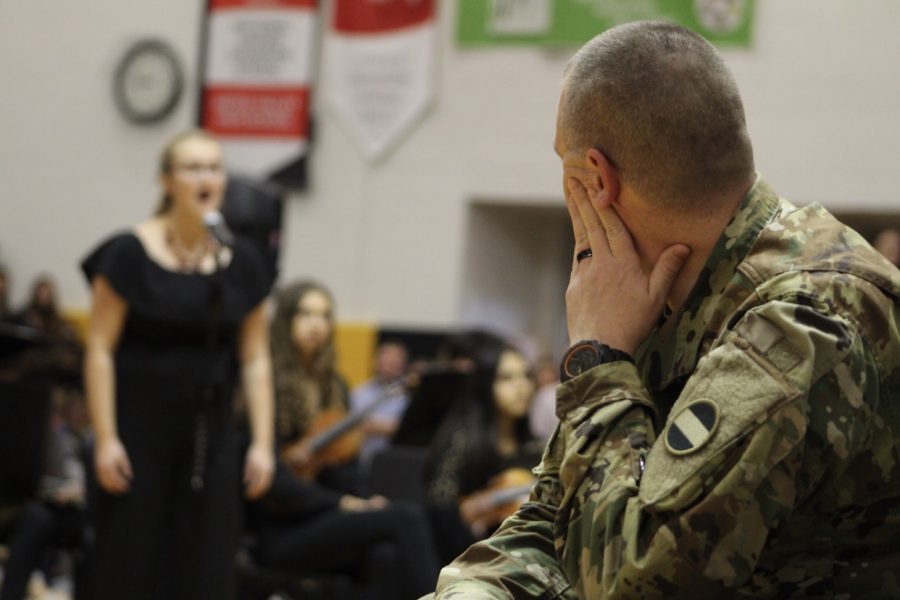 Sgt. Maj. Barry Kulinski watches varsity singers preform the star spangled banner.