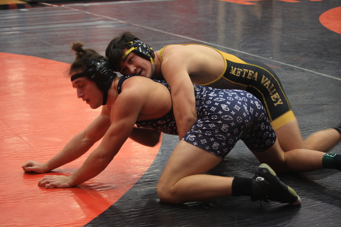Senior Sean Burke tries to take down his opponent in the first period. 
