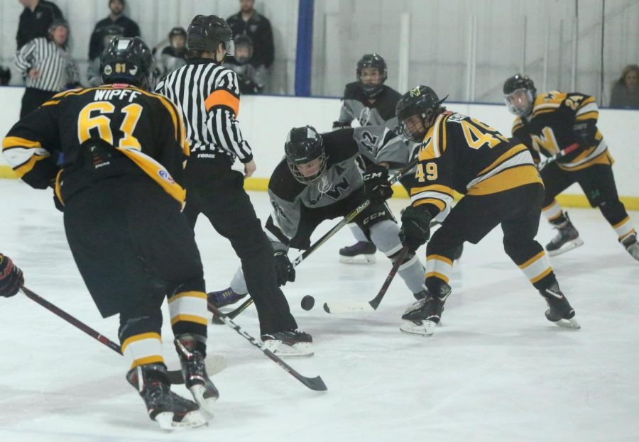 Center-man Trent Kenyon looks to gain control of the puck and pass to another teammate.