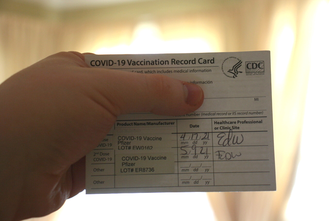 A standard-issued COVID-19 vaccination record card.