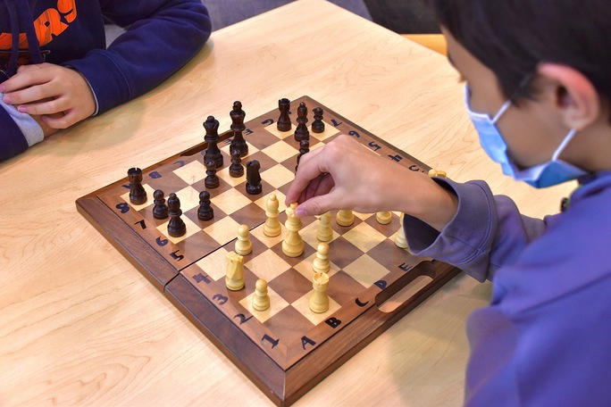 Chess team member, Matthew Bennet has a friendly game with a peer. The Mustangs refine their skills in the LMC, practicing for upcoming competitions and tournaments.