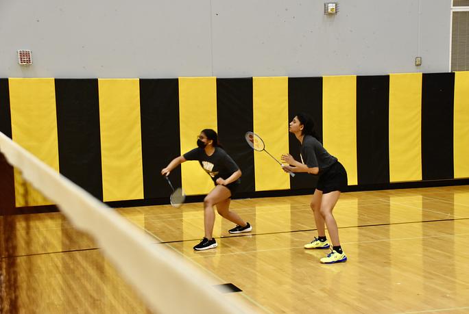 Metea+Valleys+badminton+team+faced+off+Wheaton+Warrenville+South+and+Wheaton+North+in+the+auxiliary+gym+playing+a+set+of+doubles.