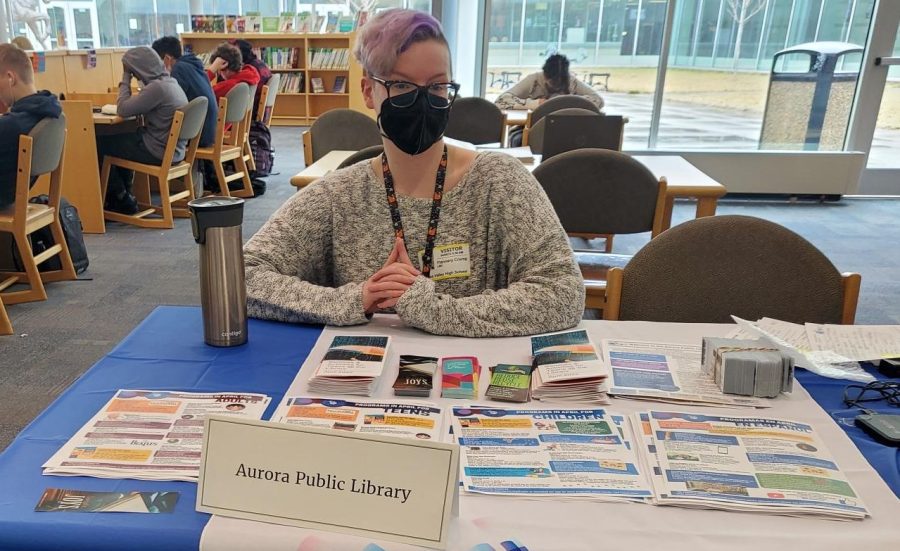Flannery Crump, teen services librarian, represents Aurora Public library in their program to offer students library cards.