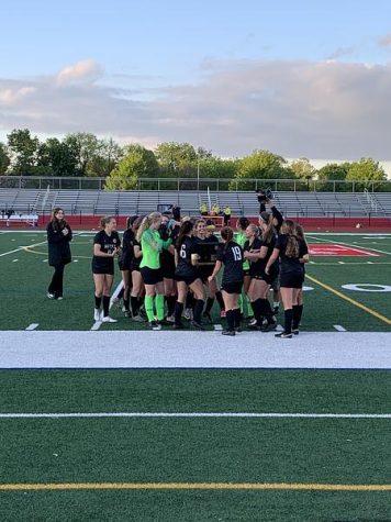 Jordan Lange taking it all in and celebrating with her team after scoring the goal to clinch Metea’s first sectional championship in girls’ soccer