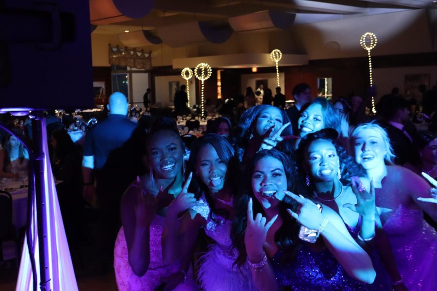 Seniors pose at the front of the dance floor. 