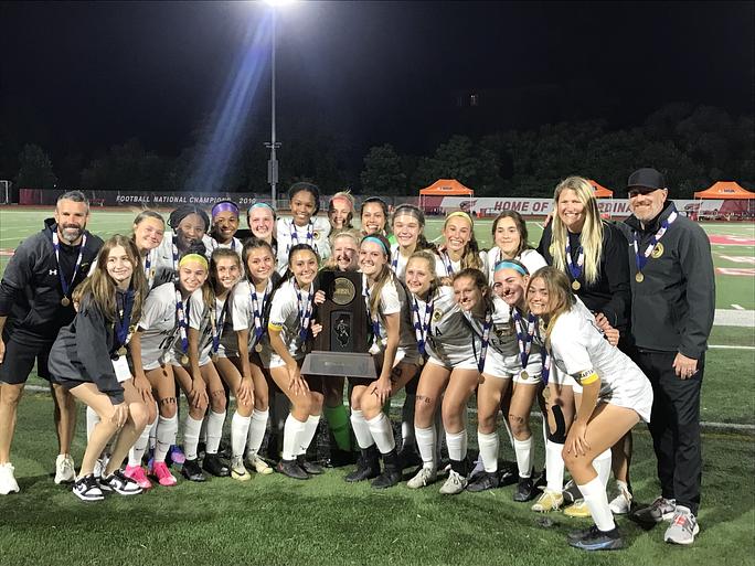 The girls’ soccer team poses for group photo at North Central with state trophie after beating Barrington.