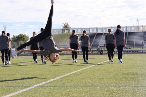 The Orchesis dancer flips through the air during their dance.
