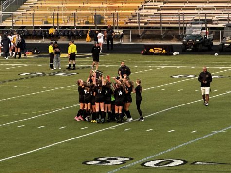Mustangs celebrate their 8-1 win against the Wildcats with their plaque.