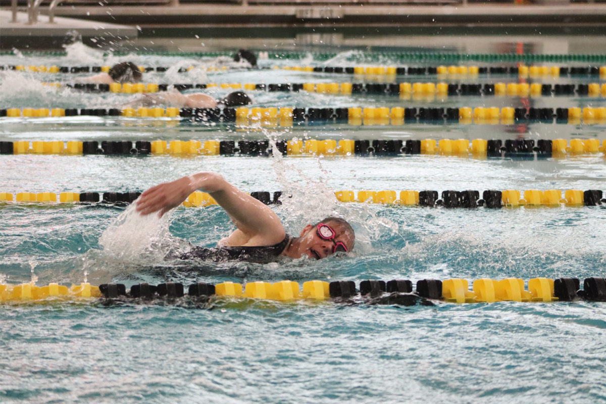 Student-athletes compete swimming, trying their best to have their best times. 