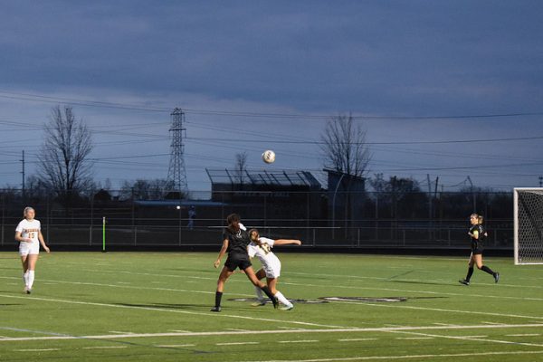 Despite the weather, Metea Valley girls soccer team still have it their all during the game.