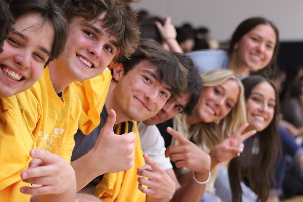 Seniors ecstatically cheer as activities happen during the assembly. 