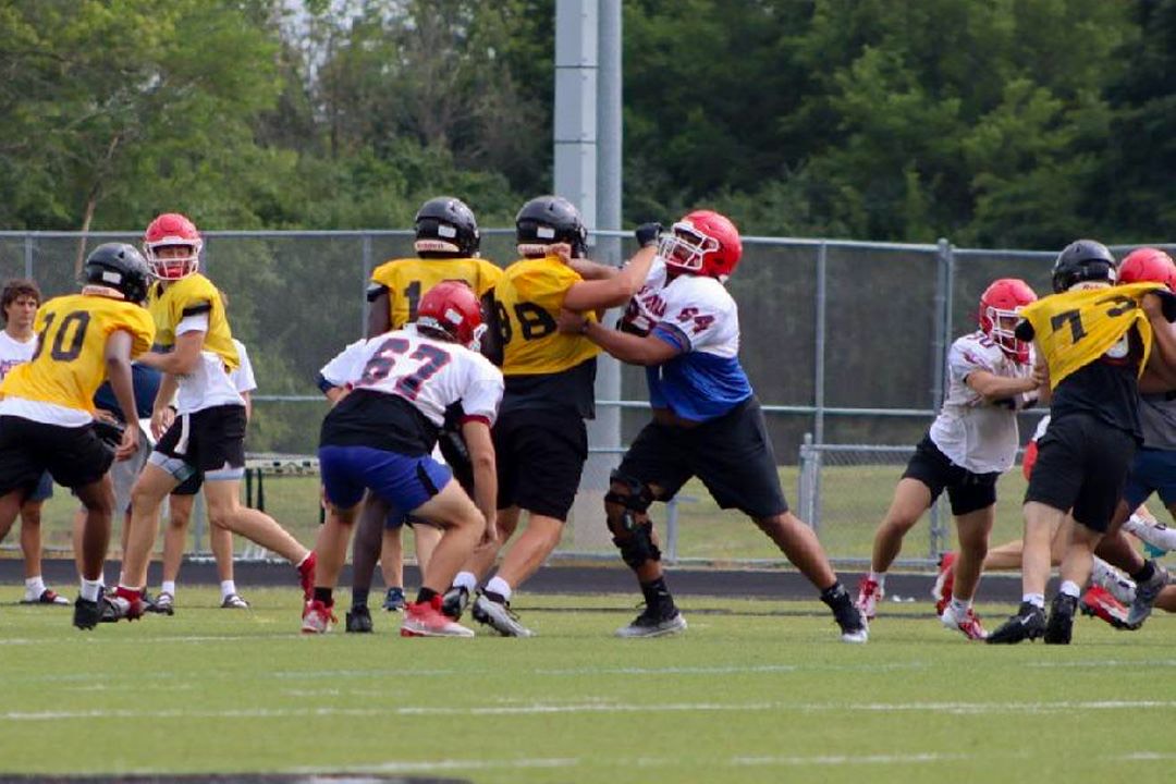 Metea athletes compete for possession of the football.