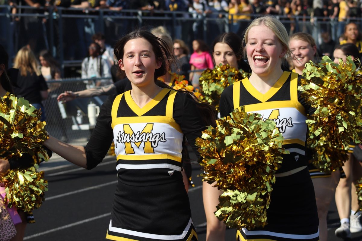 Two dance team members laugh as they do the choreography of 'Hot to Go' by Chappel Roan.