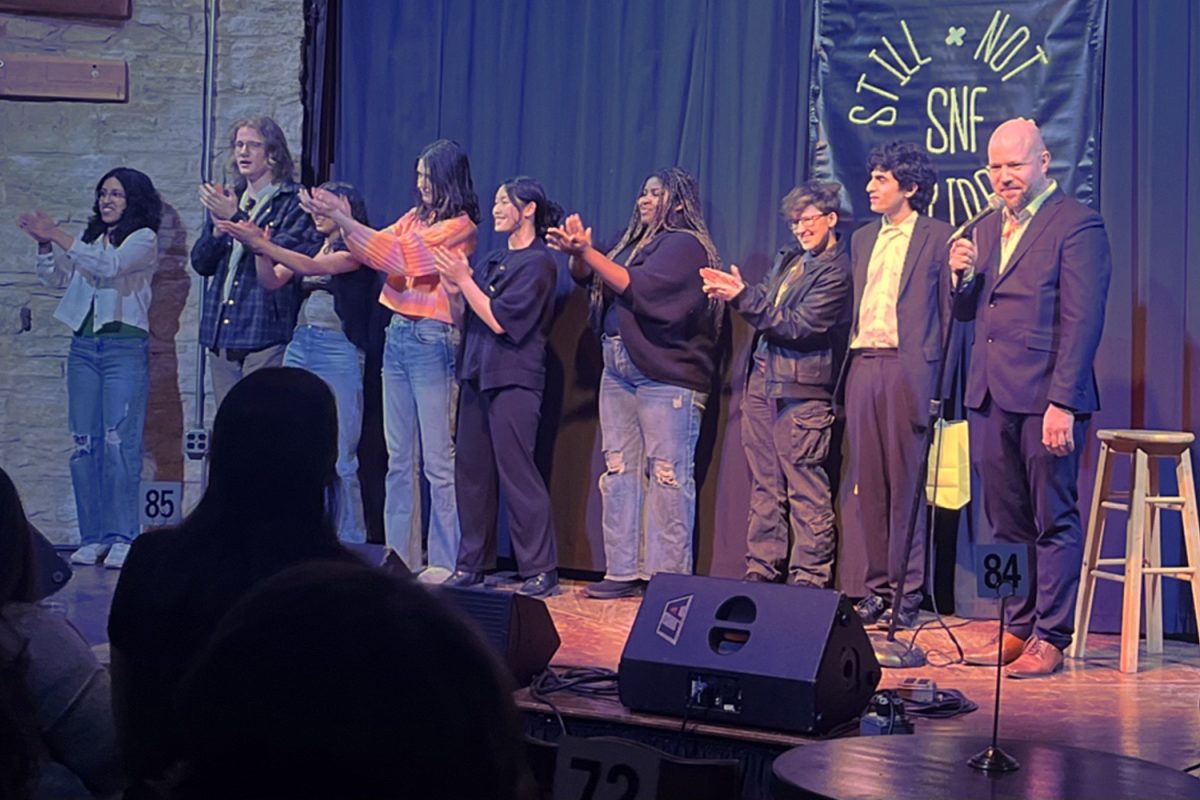  Mustang Comedy Club with Matt Drufke applauding their audience for coming to watch their show at Two Brothers Roundhouse 
New boost