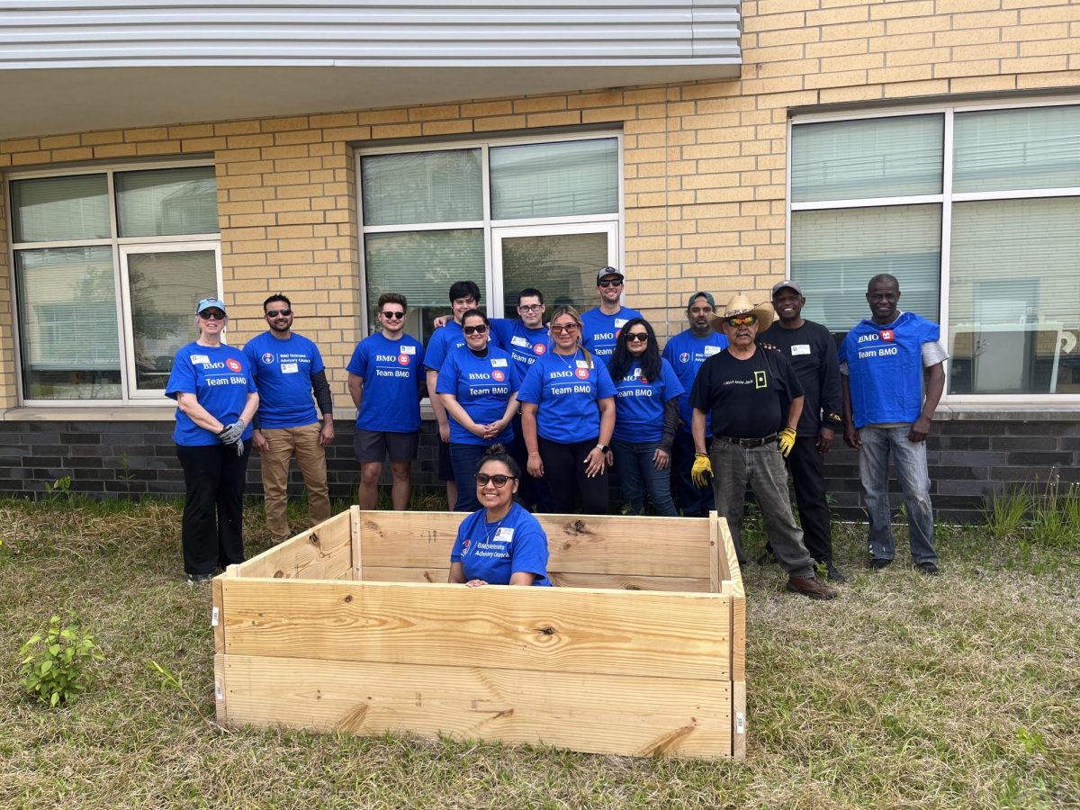 BMO-sponsored volunteers build garden beds, fostering hope and supporting the community