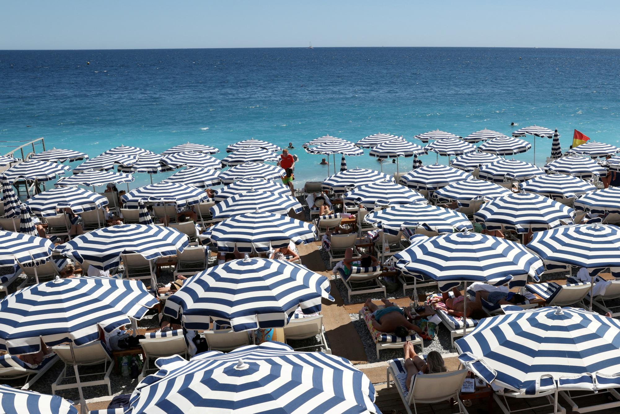 A view shows a beach with deckchairs and parasols on a sunny summer day on the Promenade des Anglais in Nice, France, July 8, 2025. REUTERS/Kevin Coombs
