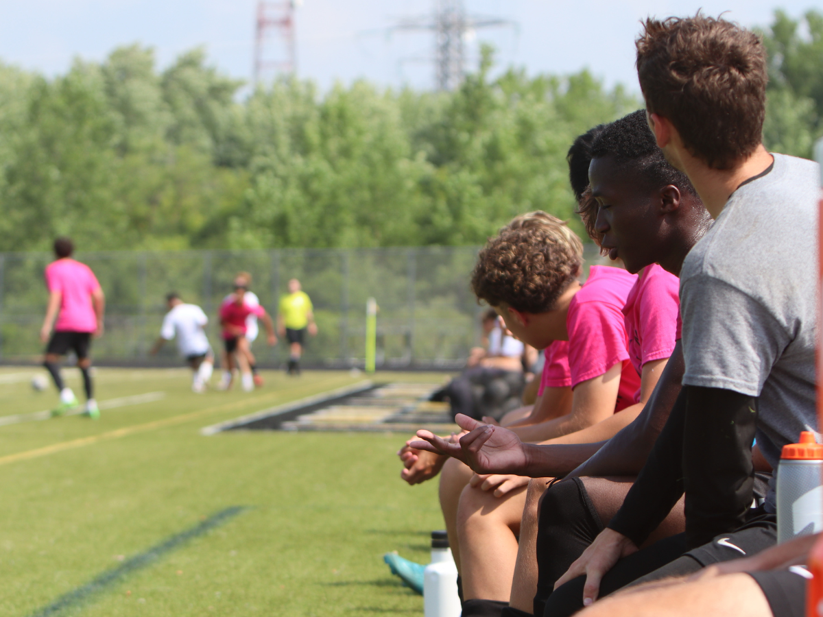 Metea players watch the game from the bench.