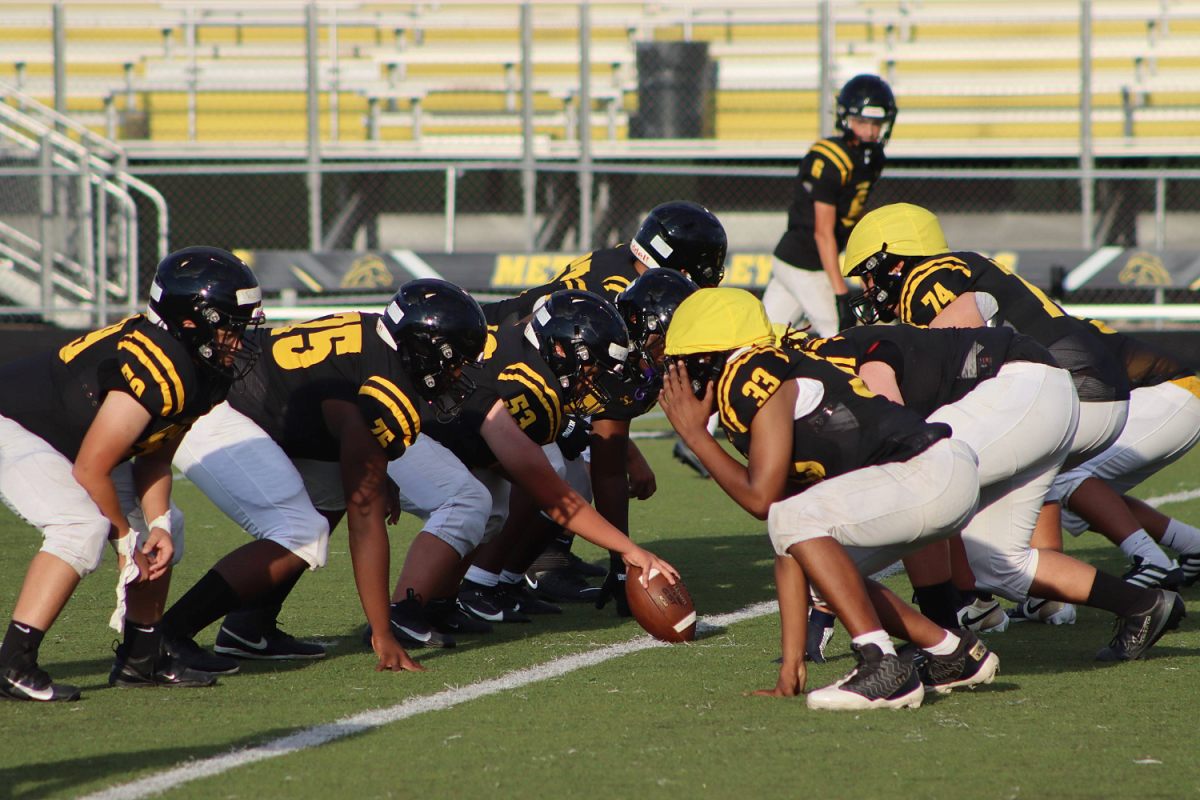 The members of the JV American Football team unite, preparing for another set of their scrimmage.