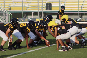 The members of the JV American Football team unite, preparing for another set of their scrimmage.