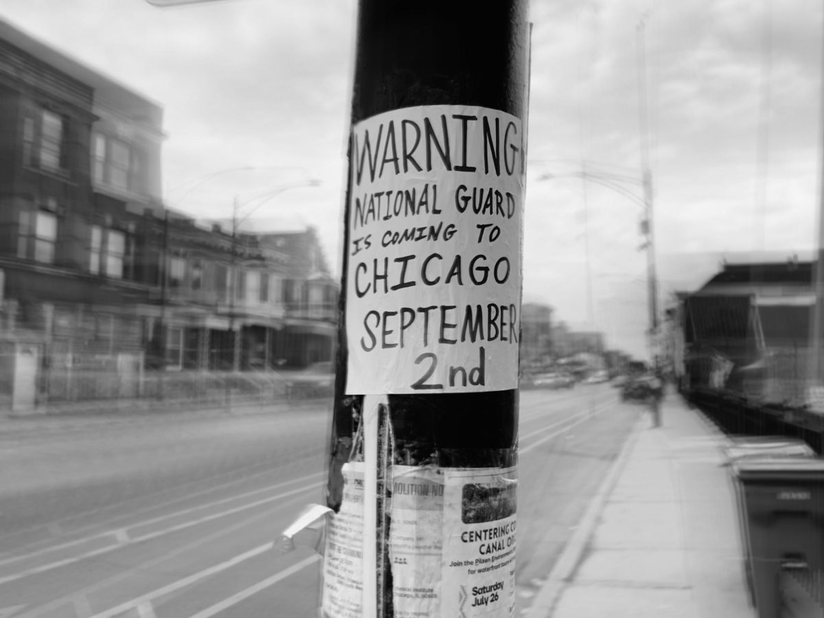 A poster on a streetlight at Barrette Charles Park that warns Chicagoans about the national guard’s potential arrival.