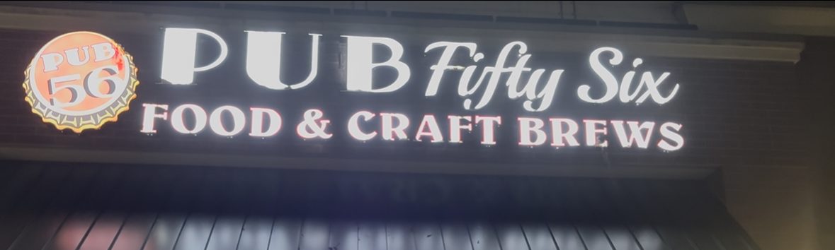 Pub Fifty Six logo illuminates in the night.