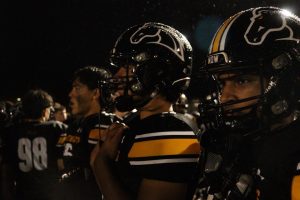 The football team standing collectively.