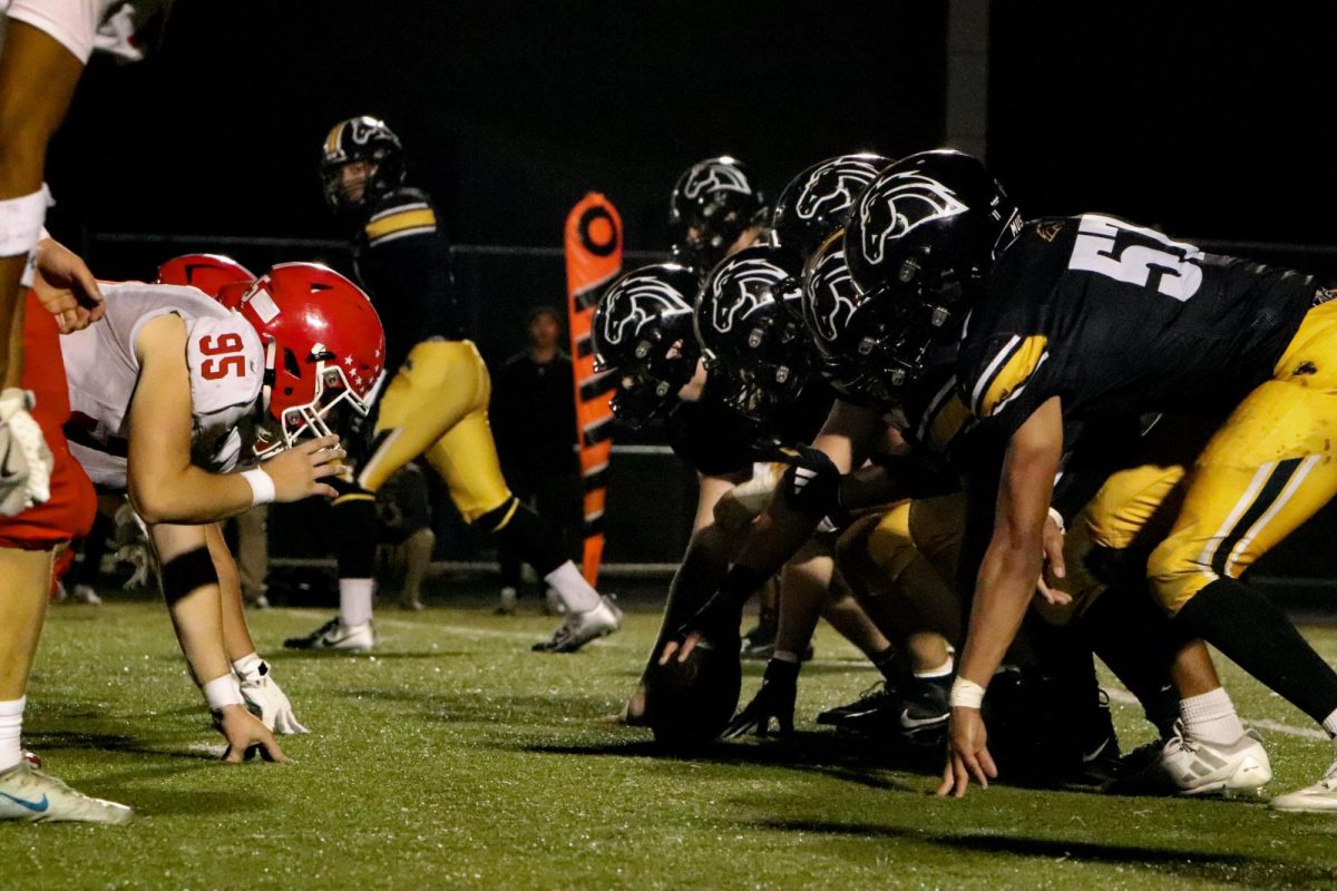 Mustangs O-line sets for the snap against the Redhawks fighting for control of the 3rd quarter.