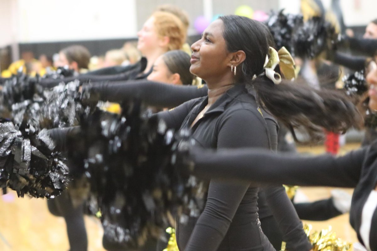 Dance team member, Neha Raja performs the Metea chant, hyping up the audience for the upcoming pep-assembly events.