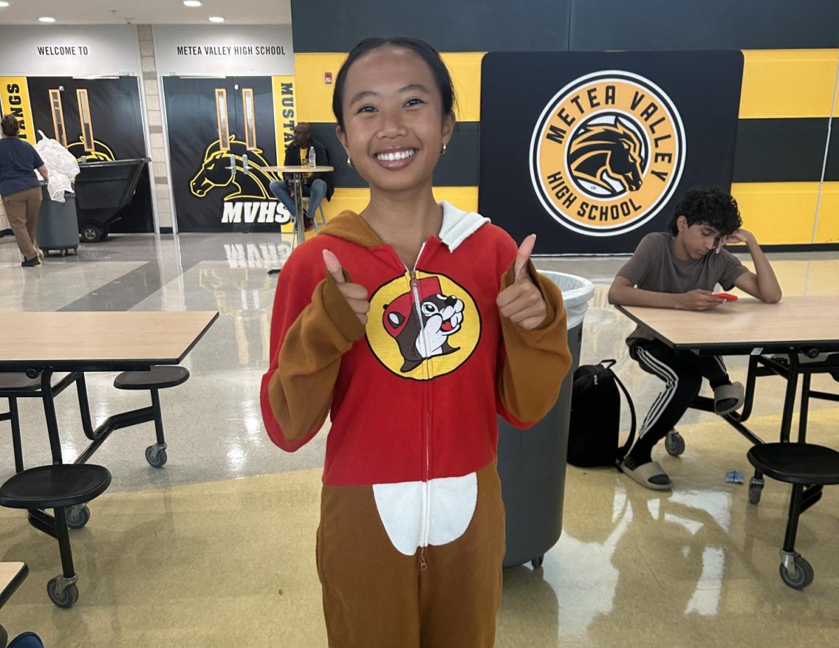 Junior Kailyn Chhe shows off her comfortable Buc-ees onesie.