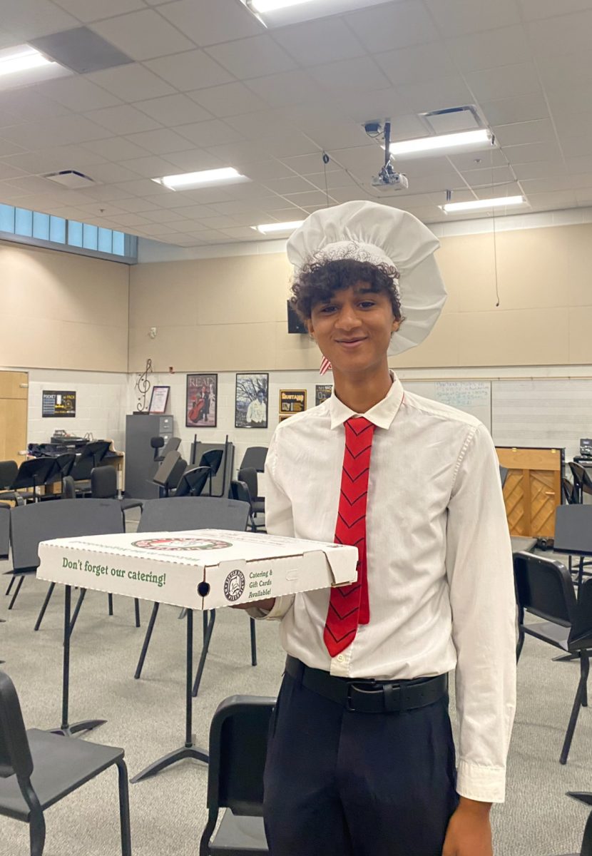 Junior Sebastian Wax brings dresses up as a chef with a pizza box to hold his supplies.