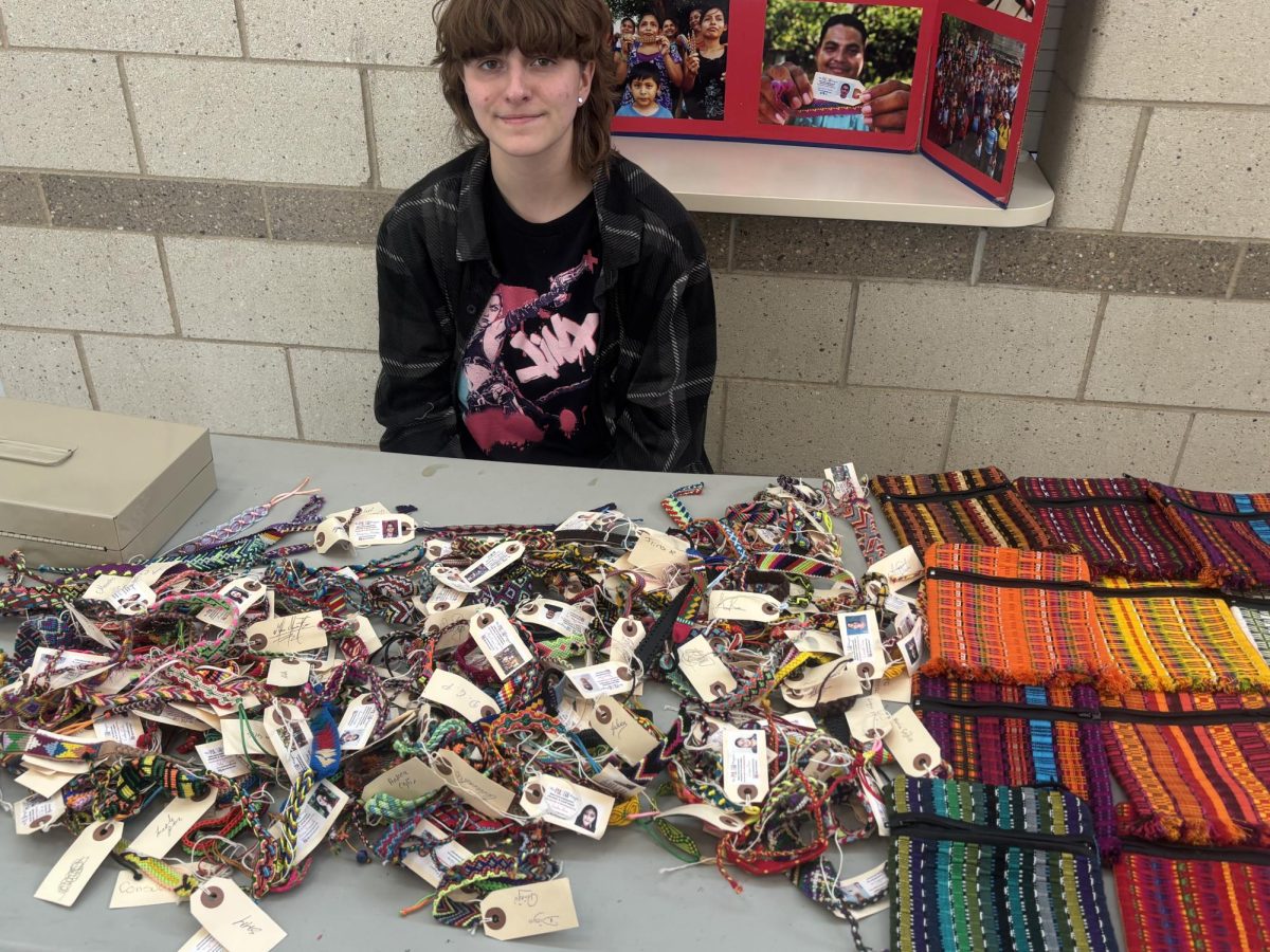 Senior Gray Parli is seen selling handmade pulseras and bolsitas from Nicaragua. Helping to raise funds for essential programs and central America.