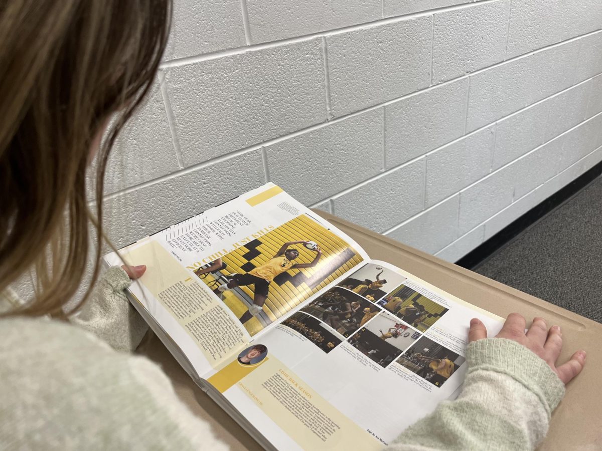Students admire the yearbook to celebrate the National Press Association Award.