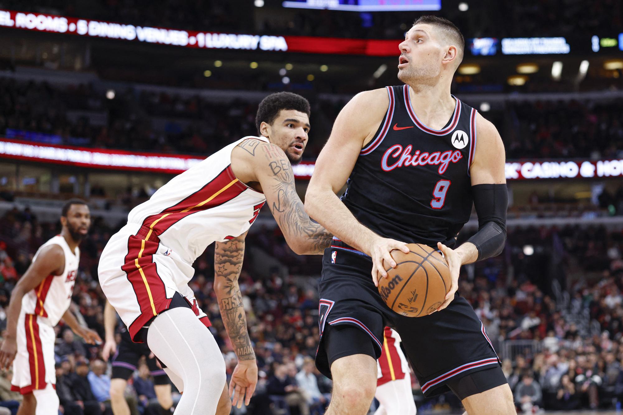 Jan 29, 2026; Chicago, Illinois, USA; Chicago Bulls center Nikola Vucevic (9) looks to shoot against Miami Heat center Kel'el Ware (7) during the first half at United Center. Mandatory Credit: Kamil Krzaczynski-Imagn Images