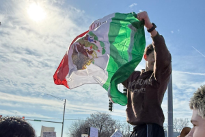 Student holds up Mexico flag in protest of increased ICE operations.