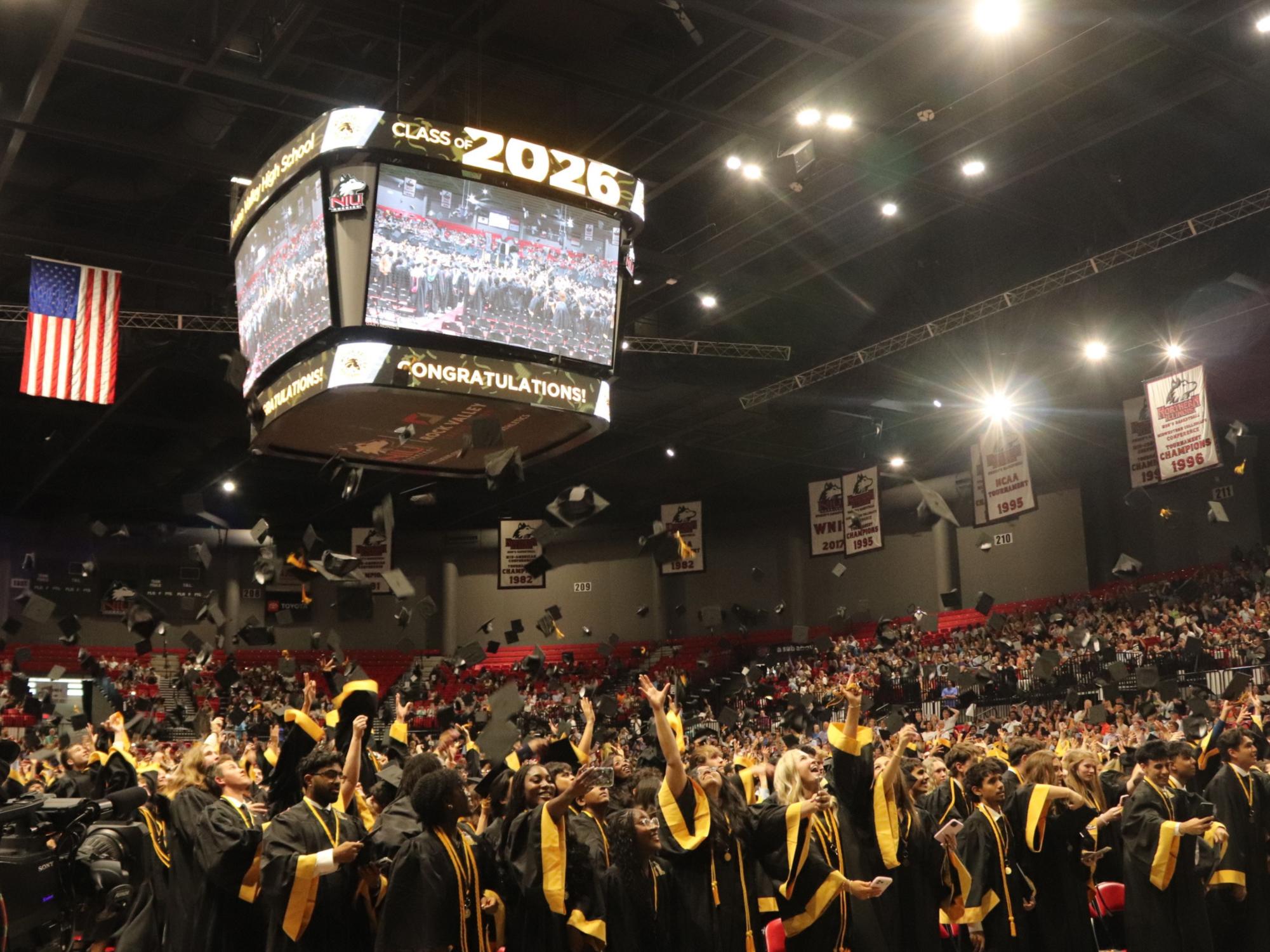 The graduates throw their hats as they finish their last year of high school.